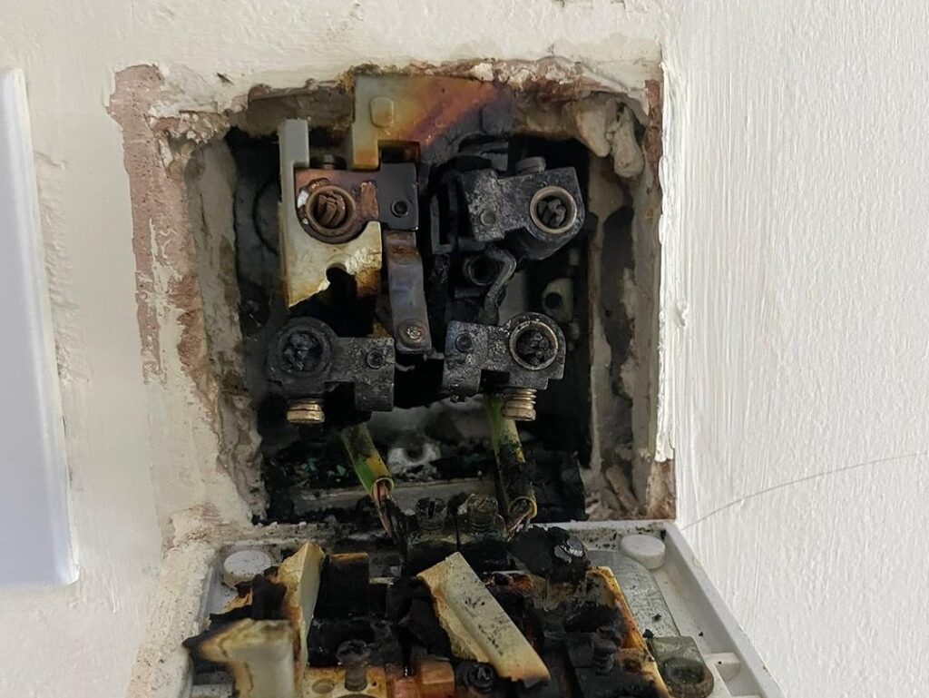 Burnt-out electrical socket needing emergency electrician repair