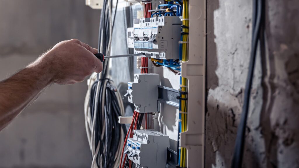 Electrician installing new wiring and circuits in a Ferndown property